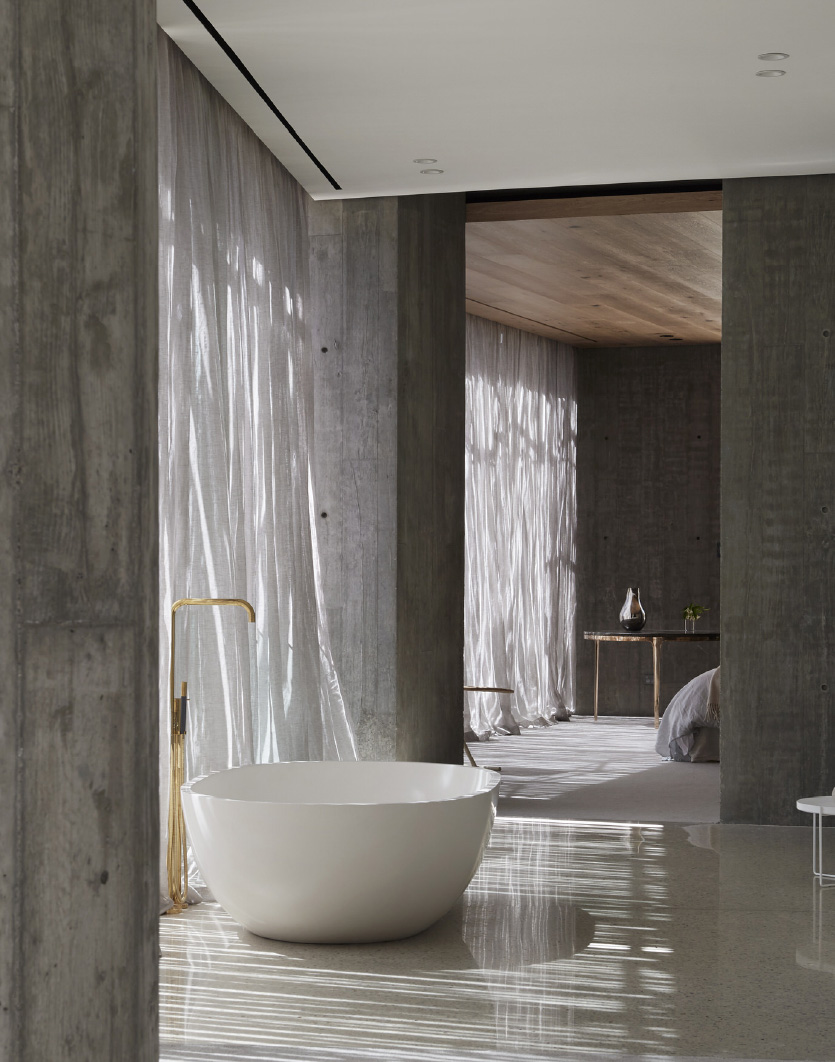 large luxury freestanding bath in a spacious room with dappled light