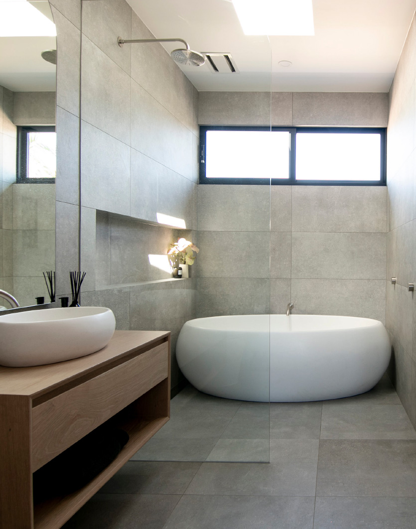 a narrow bathroom with apaiser Lotus freestanding bath, a shower cabin and a vanity